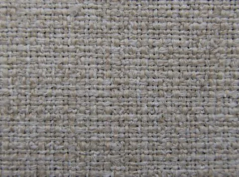 Full frame background of neutral coloured textured fabric with copyspace Stock Photos