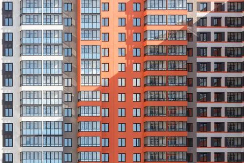 Full frame background of new high rise apartament building wall with multiple Photos