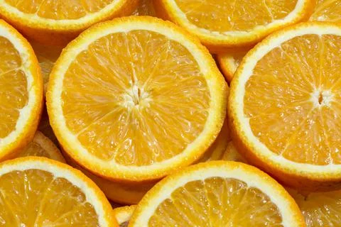 Full frame background with orange slices. Cross-section of an orange fruit Stock Photos