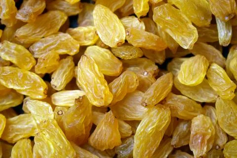 Full frame background pattern of sweet yellow kismis dried fruit grocery pr.. Stock Photos