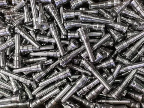 Full frame background of pile of shiny long steel parts, clean steel rods after Stock Photos