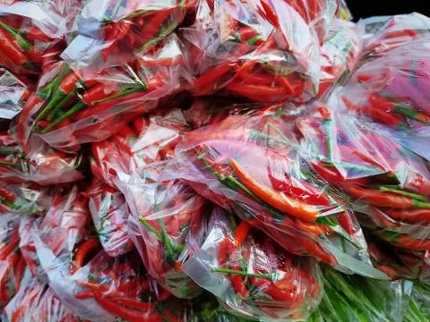 Full Frame Background of Red Hot Chilies in Plastic Bags Stock Photos