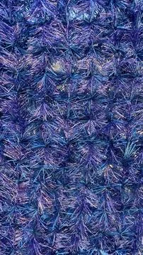 Full frame background of shimmering blue and violet metallic tinsel with fe.. 写真素材