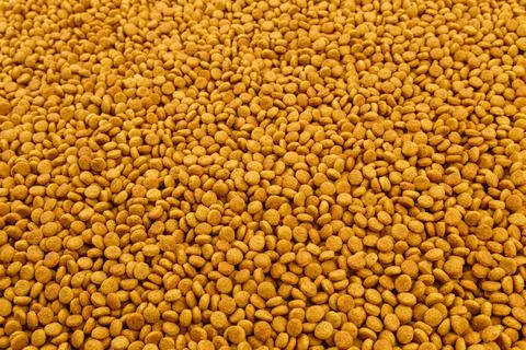 Full frame background of small dry orange cat food crockets Stock Photos