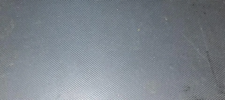 Full frame background texture of a dark grey metallic grid pattern Stock Photos