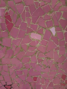 Full frame background texture of shattered pink ceramic mosaic tiles set in m Stock Photos