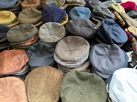 Full frame background texture of various traditional flat caps, newsboy hat.. Stock Photos