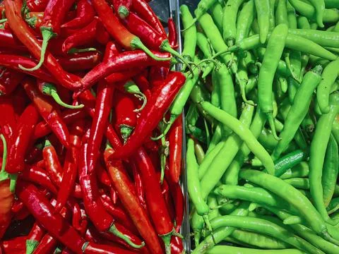 Full Frame Background of Two Halves of Red and Green Chilies for Sale Stock Photos