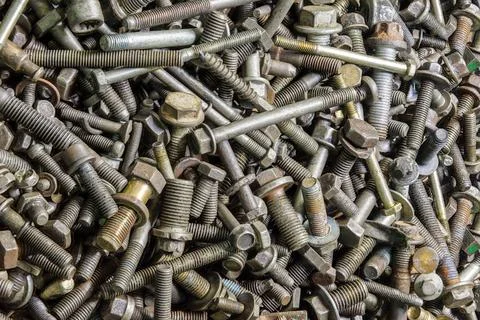 Full frame background of used automobile bolts heap, old and dirty Stock Photos