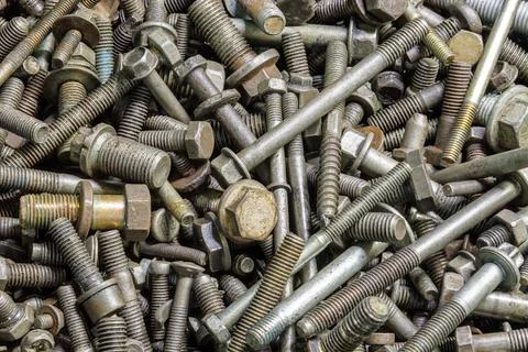 Full frame background of used automobile bolts heap, old and dirty Stock Photos