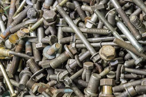 Full frame background of used automobile bolts heap, old and dirty Stock Photos
