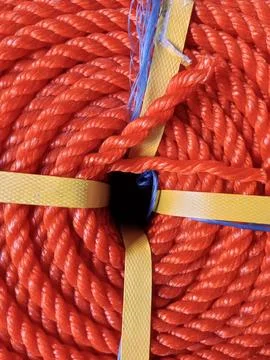 Full frame of bundle of orange rubber fiber rope coil. Stock Photos