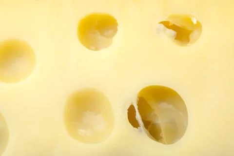 Full frame of cheese with holes Stock Photos