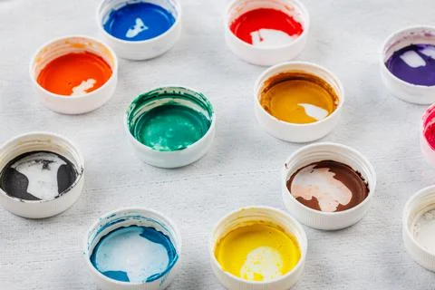Full-frame close-up background of gouache paint jar caps Stock Photos