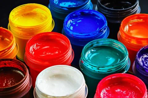 Full-frame close-up background of opened small gouache paint jars Stock Photos