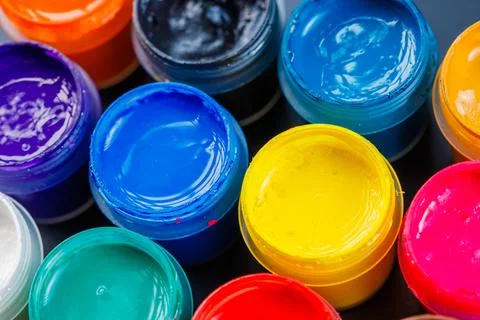 Full-frame close-up background of opened small gouache paint jars Stock Photos