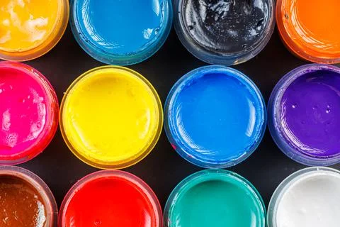 Full-frame close-up background of opened small gouache paint jars Stock Photos