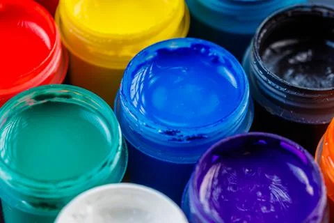 Full-frame close-up background of opened small gouache paint jars Stock Photos