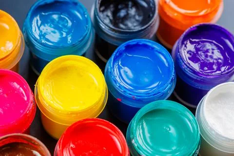 Full-frame close-up background of opened small gouache paint jars Stock Photos