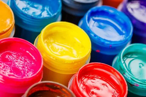 Full-frame close-up background of opened small gouache paint jars Stock Photos