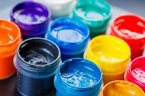 Full-frame close-up background of opened small gouache paint jars Stock Photos