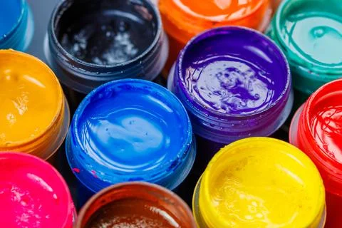 Full-frame close-up background of opened small gouache paint jars Stock Photos