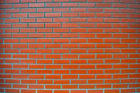 A full frame close-up of an exterior red brick wall showing multiple rows o.. Stock Photos