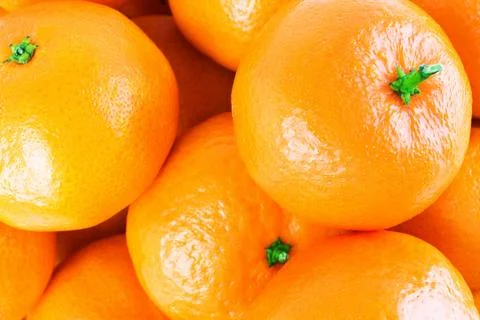 Full frame close-up of fresh ripe tangerines. Bright orange citrus fruits t.. Stock Photos