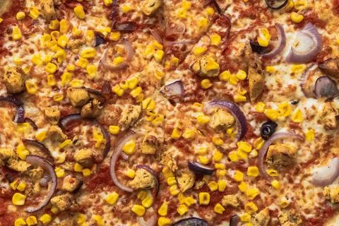 Full frame close up of pizza toppings with sweet corn, red onion rings and Stock Photos