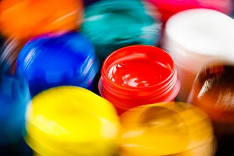 Full-frame close-up view of opened gouache paint jars with natural motion blur Stock Photos