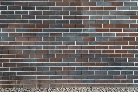 Full frame of dark brick wall with uniform mortar joints Fotos de archivo