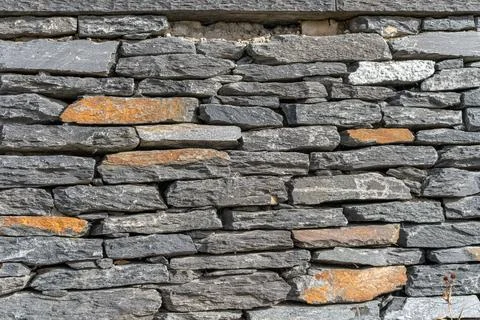 Full Frame Dry Stone Wall with Layered Gray and Rust Colored Rocks Stock Photos