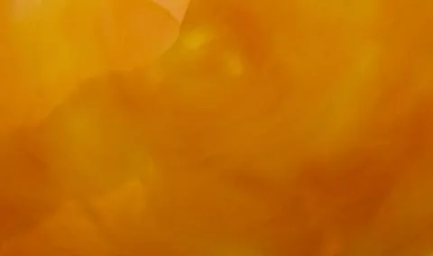 Full frame egg yolk background in mottled shades of dark yellow Stock Photos