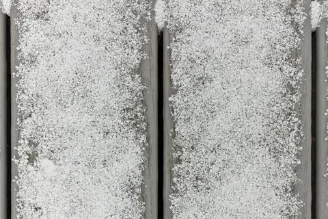 Full Frame Flatlay of A Thin Fresh Layer of Graupel Snow on Gray Deck Boards Stock Photos