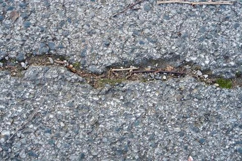 Full frame grunge background of cracked old asphalt pavement Stock Photos