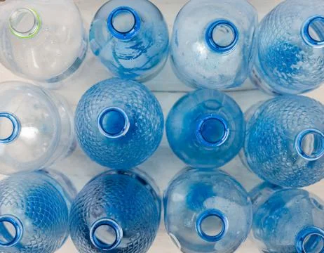 Full frame high angle view  shot of blue empty glass bottles on table . Stock Photos
