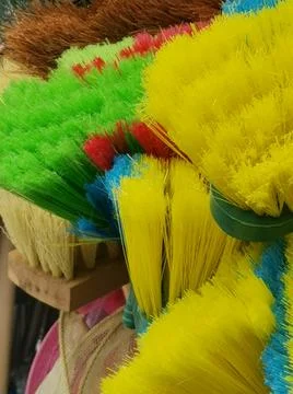 Full frame image of assorted nylon and bristle brooms in bright colours Stock Photos