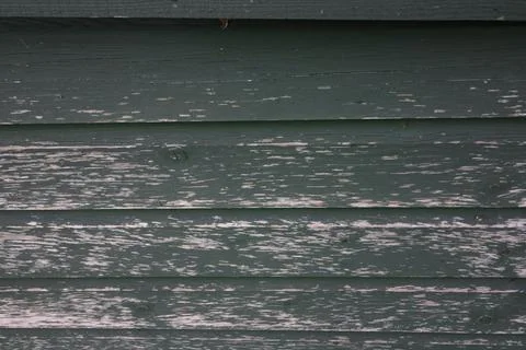 Full frame image of painted dark green wood which is peeling Stock Photos
