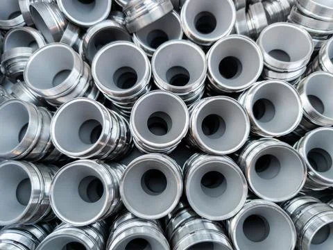 Full frame industrial background of turned shiny round steel parts 库存照片