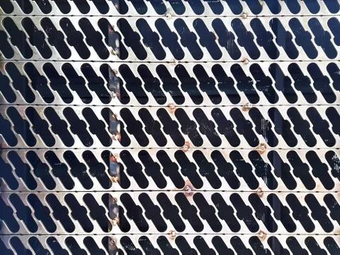 Full Frame Industrial Pattern Background of Punched Slots on Metal Plate Stock Photos