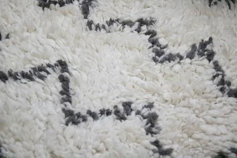 Full frame interior background of white shaggy rug with zig zag pattern 스톡 사진