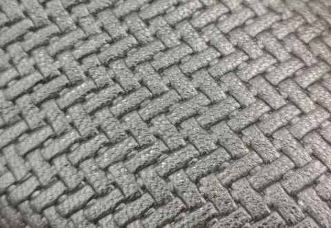 Full frame mid grey herringbone textured fabric background with copyspace Stock Photos