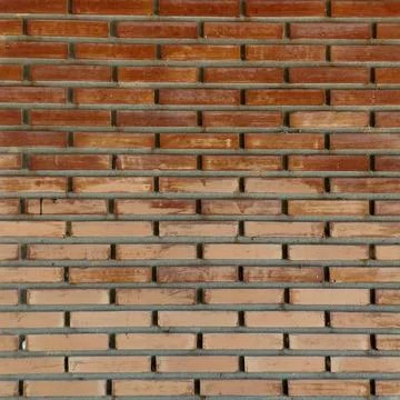 Full frame of a modern brown and terracotta brick wall texture. Stock Photos
