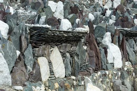 Full-frame multi-colored stacked stone wall background for design Stock Photos