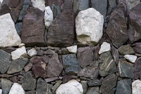 Full-frame multi-colored stacked stone wall background for design Stock Photos