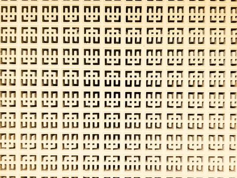 Full Frame Pale Beige Repeating Geometric Pattern Texture of Perforated Blocks W 写真素材