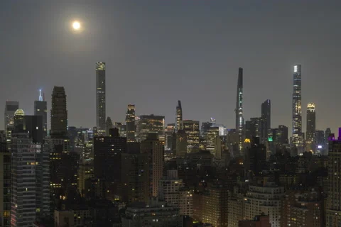 Full frame Penumbral Eclipse Moon over Midtown Skyline (1 of 3) Stock Footage 155159456