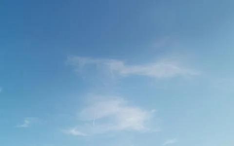 Full frame of pretty blue sky with wispy white cloud formation Stock Photos