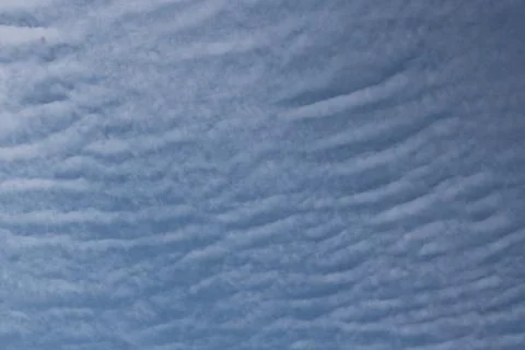 Full frame of pretty blue sky with unusual scudding cloud formation Stock Photos