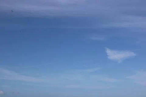 Full frame of pretty blue sky with soft scudding cloud formation Stock Photos